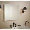 Kohler 30" W x 26" H aluminum two-door medicine cabinet with mirrored doors, beveled edges