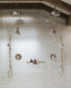 Perrin & Rowe Edwardian shower fixtures and metal-handle handshower in a silver-toned shower setting