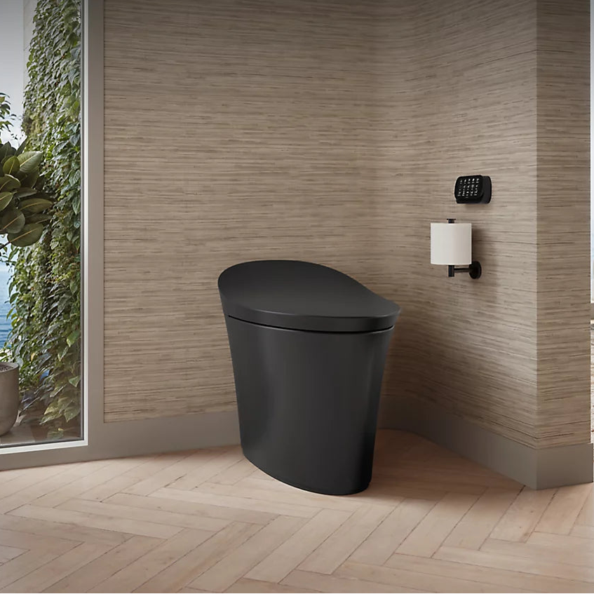 Modern black Kohler toilet in a bathroom with wooden flooring and a window view.