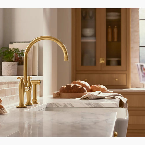 Kohler Two-hole bridge kitchen sink faucet with side sprayer
