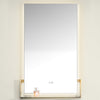 Rectangular mirror with gold frame on a white wall