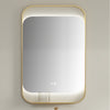 Rectangular mirror with gold frame on a light gray wall