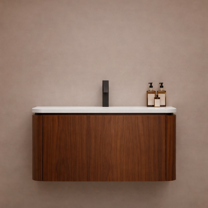 Bathroom vanity with wooden cabinet, white countertop, and black faucet against a beige wall.