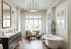 Perrin & Rowe Georgian Era column-spout lavatory faucet and traditional tub filler in a silver-toned bathroom interior