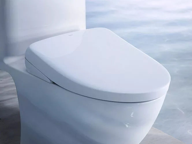 TOTO WASHLET bidet seat installed on a toilet in a bathroom