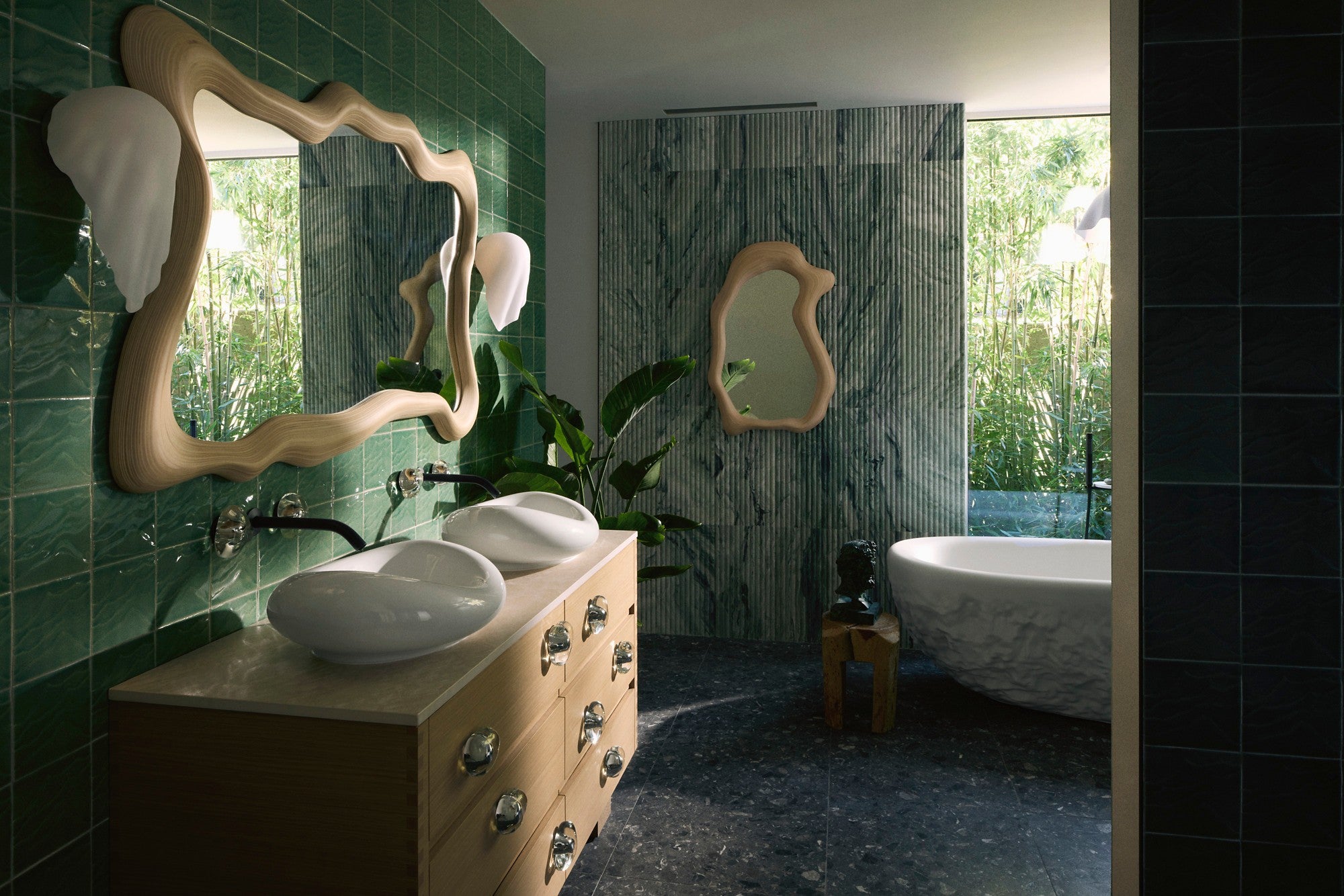 Kohler Arsham Landshapes bathroom with sculptural basins, wood vanity, organic mirrors and green tiles